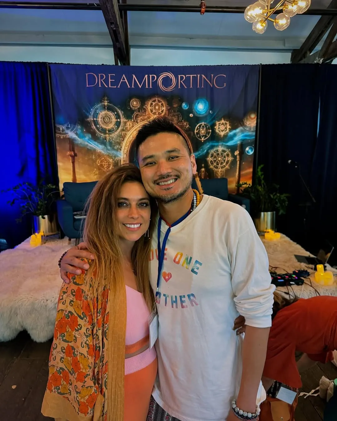 Patrick Chan with a woman in front of a Dreamporting backdrop