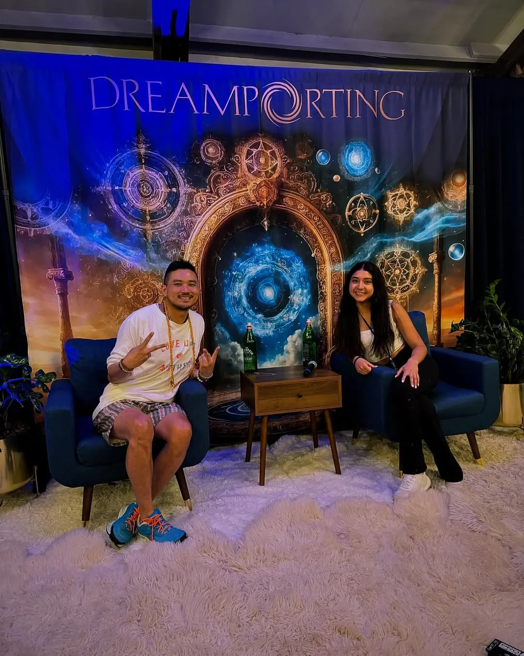 Patrick Chan and a woman seated in armchairs on a Dreamporting stage